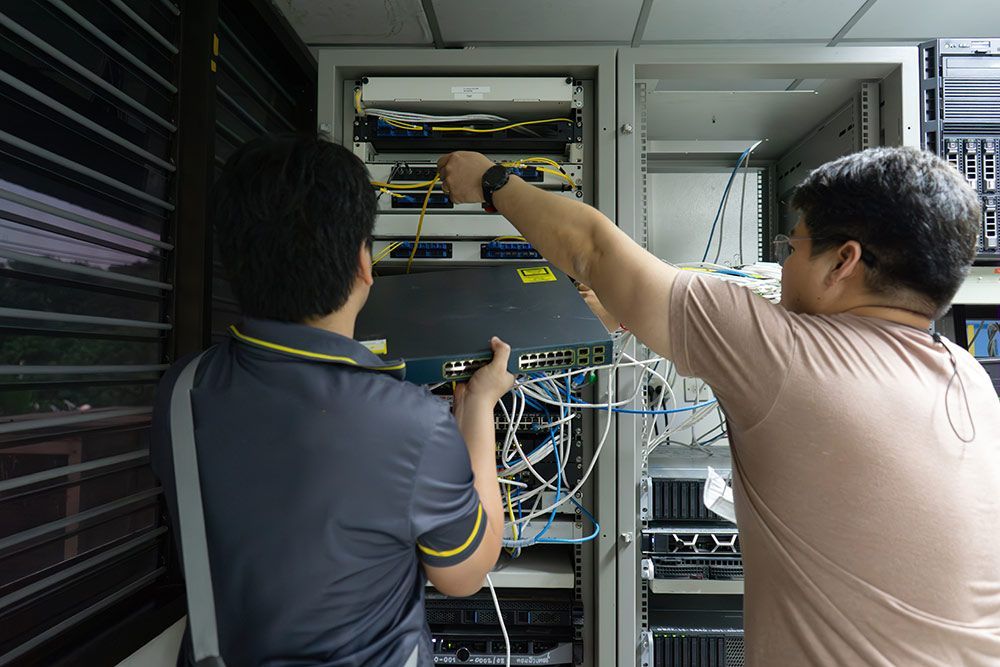 Two Men Are Working on a Server in a Server Room — Frontier Connect in Kingaroy, QLD