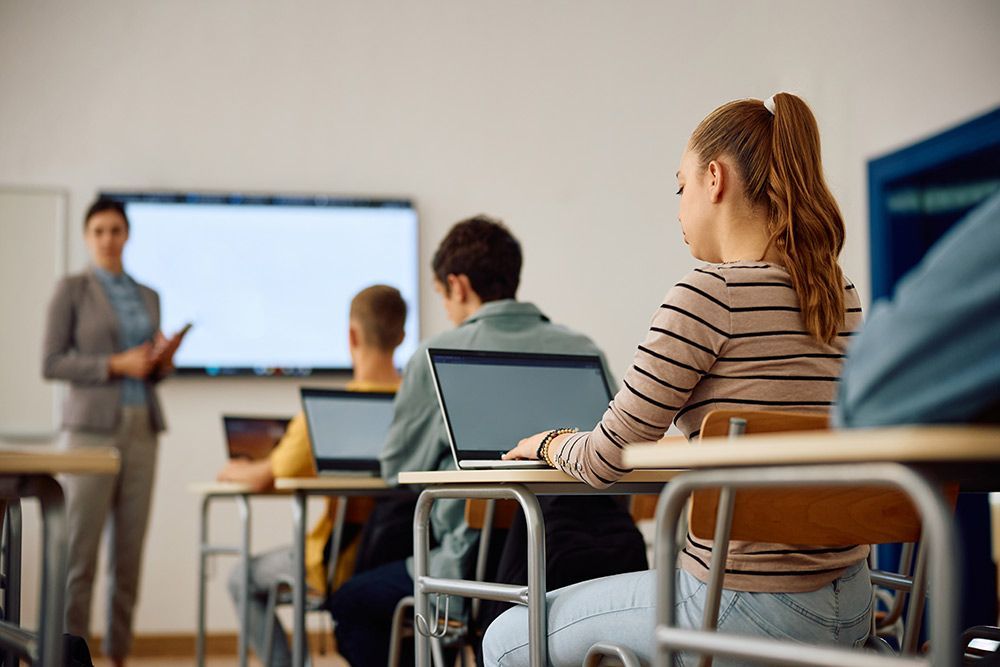 A Group of Students Are Sitting at Desks in a Classroom With Laptops — Frontier Connect in Dalby, QLD