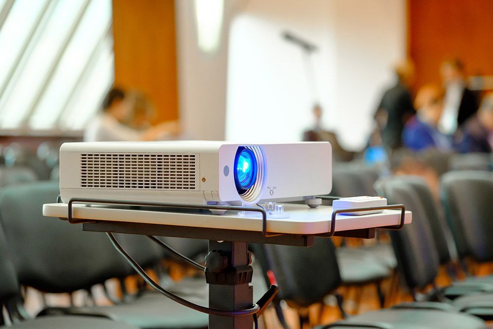 A Projector is Sitting on Top of a Table in a Conference Room — Frontier Connect in Roma, QLD