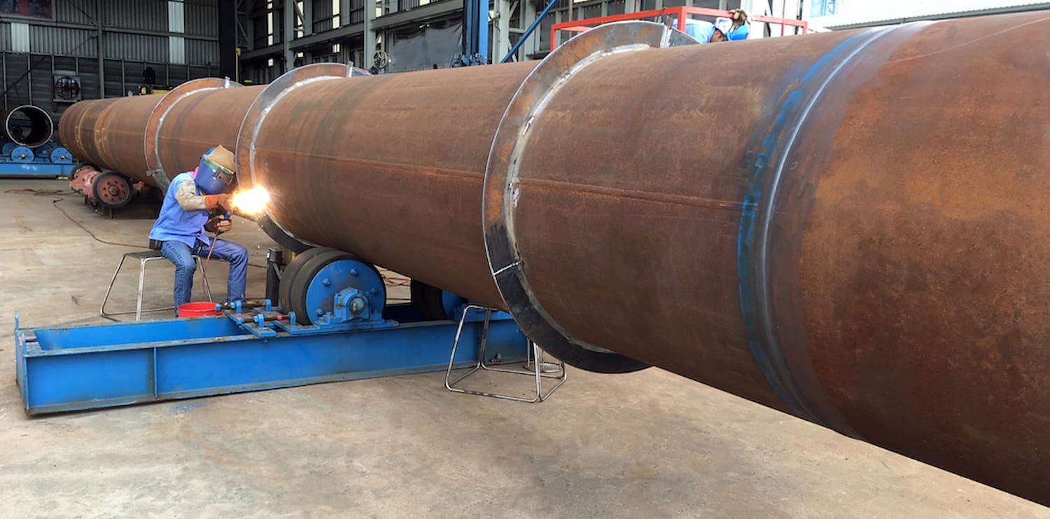 A Worker Welds a Large Cylindrical Metal Object — Forcequip In Mount Isa, QLD