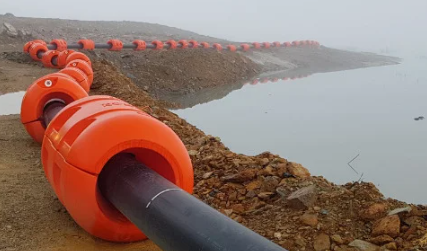 Black Pipe With Orange Floats on Muddy Shoreline — Forcequip Hire In Mackay, QLD