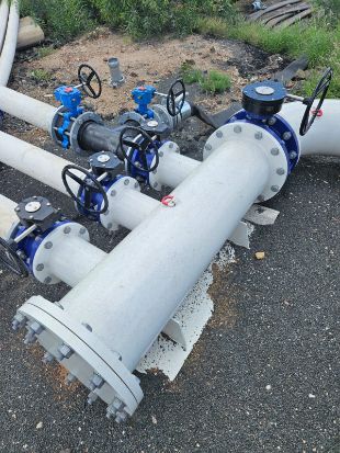 Black Pipes and Valve Against a Dusty — Forcequip Hire In Glanmire, QLD