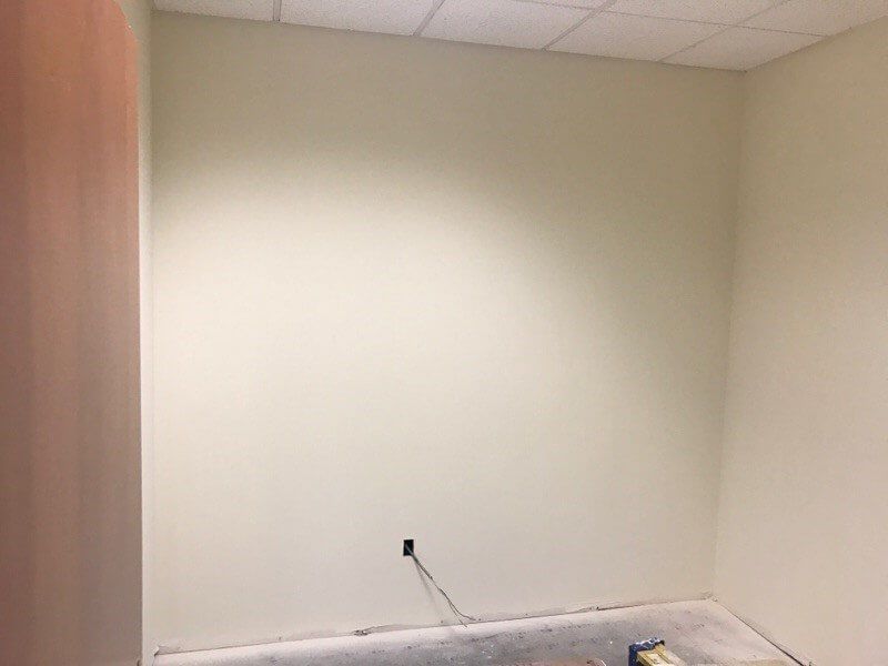 An empty room with white walls and a ceiling.