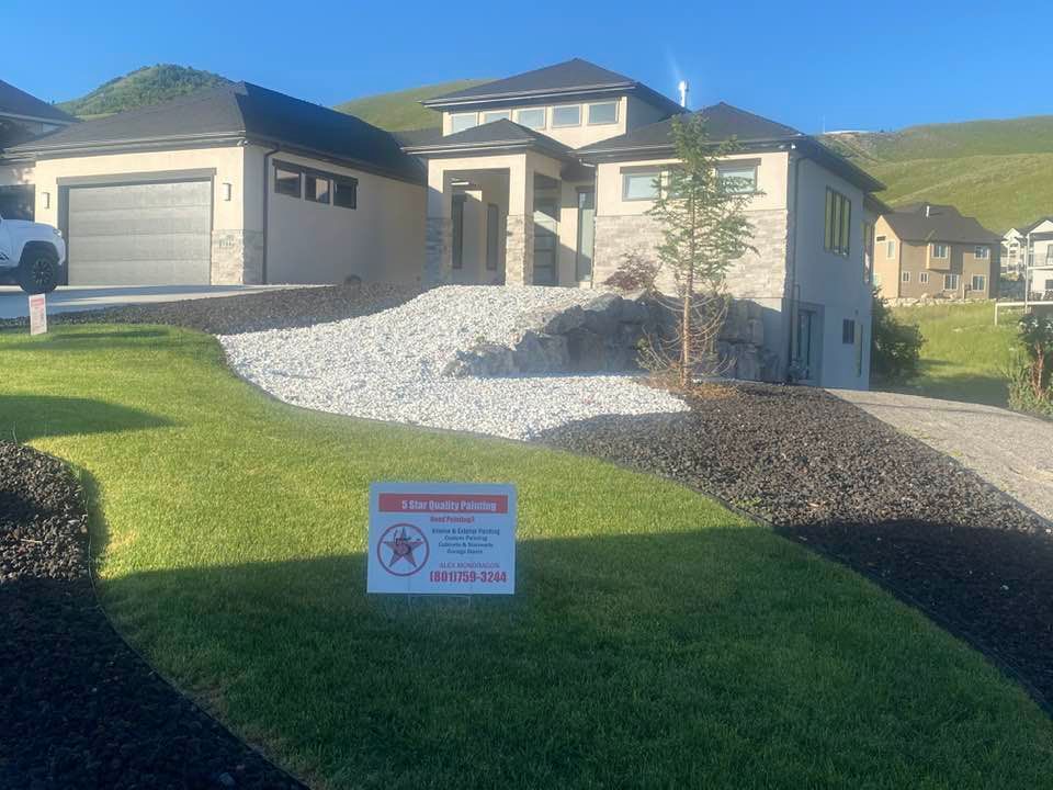 A large house with a sign in front of it.