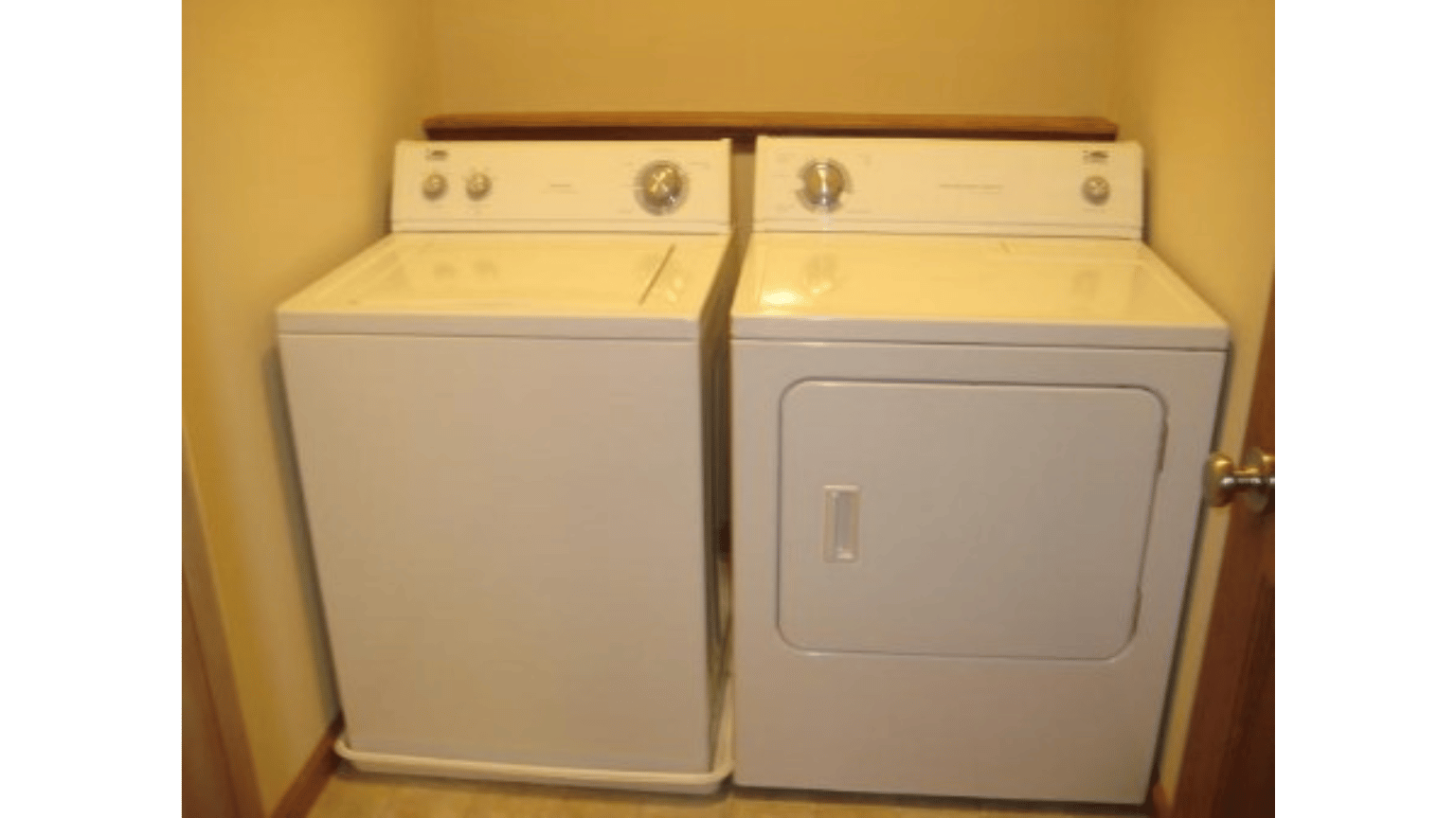 A washer and dryer are sitting next to each other in a laundry room.