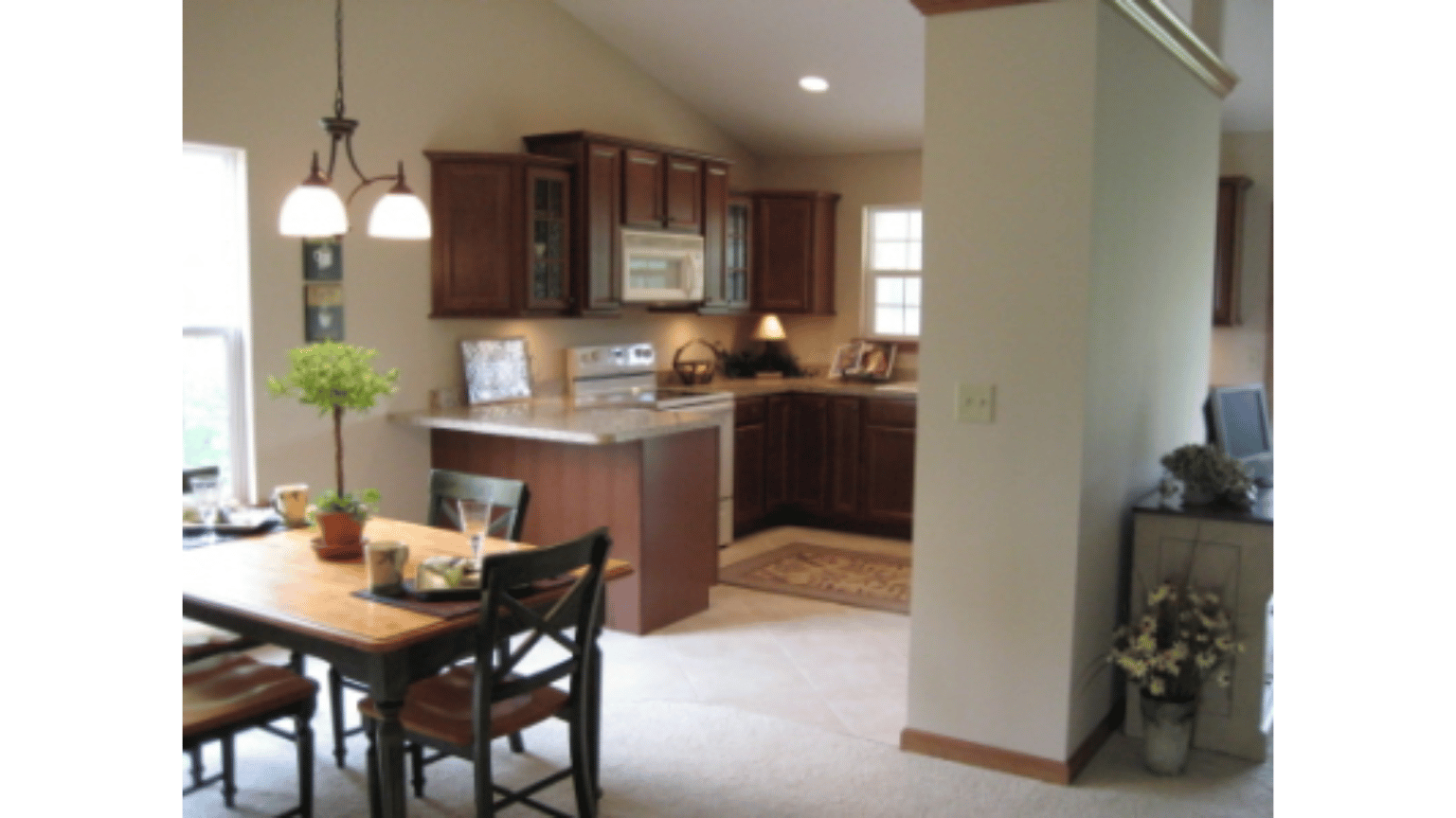 A kitchen with a table and chairs in it