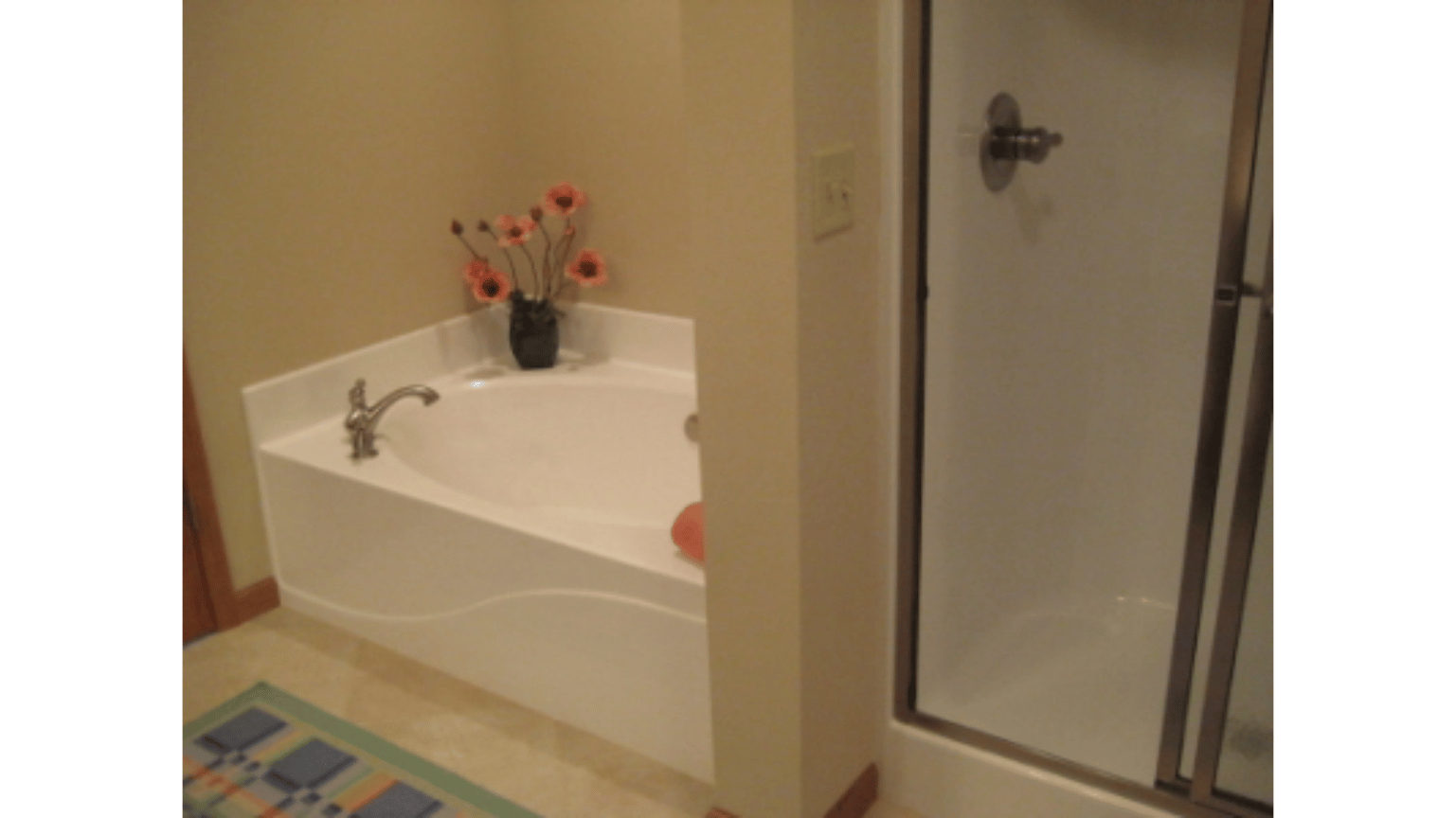 A bathroom with a bathtub and a shower.