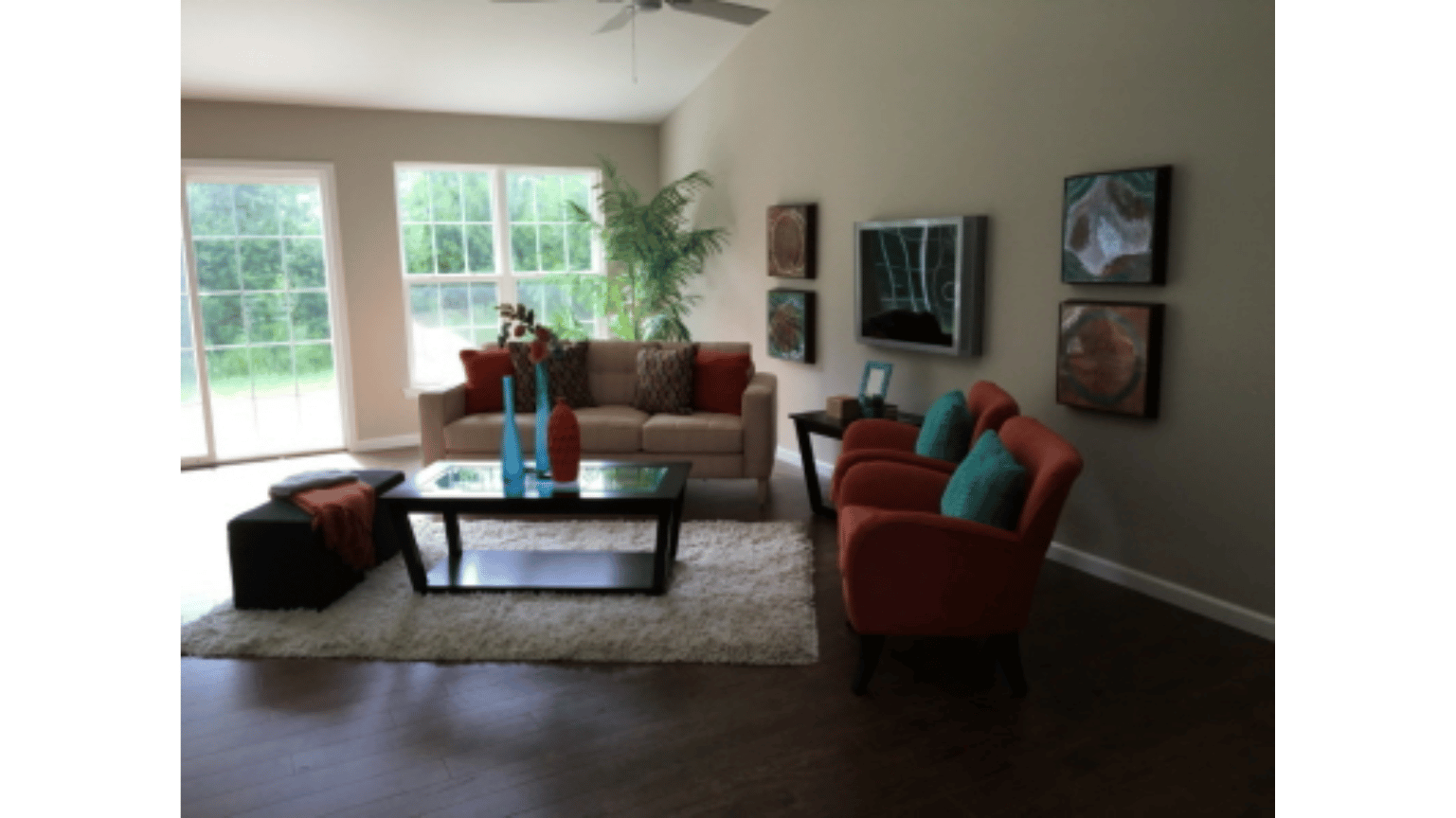 A living room with a couch and two chairs