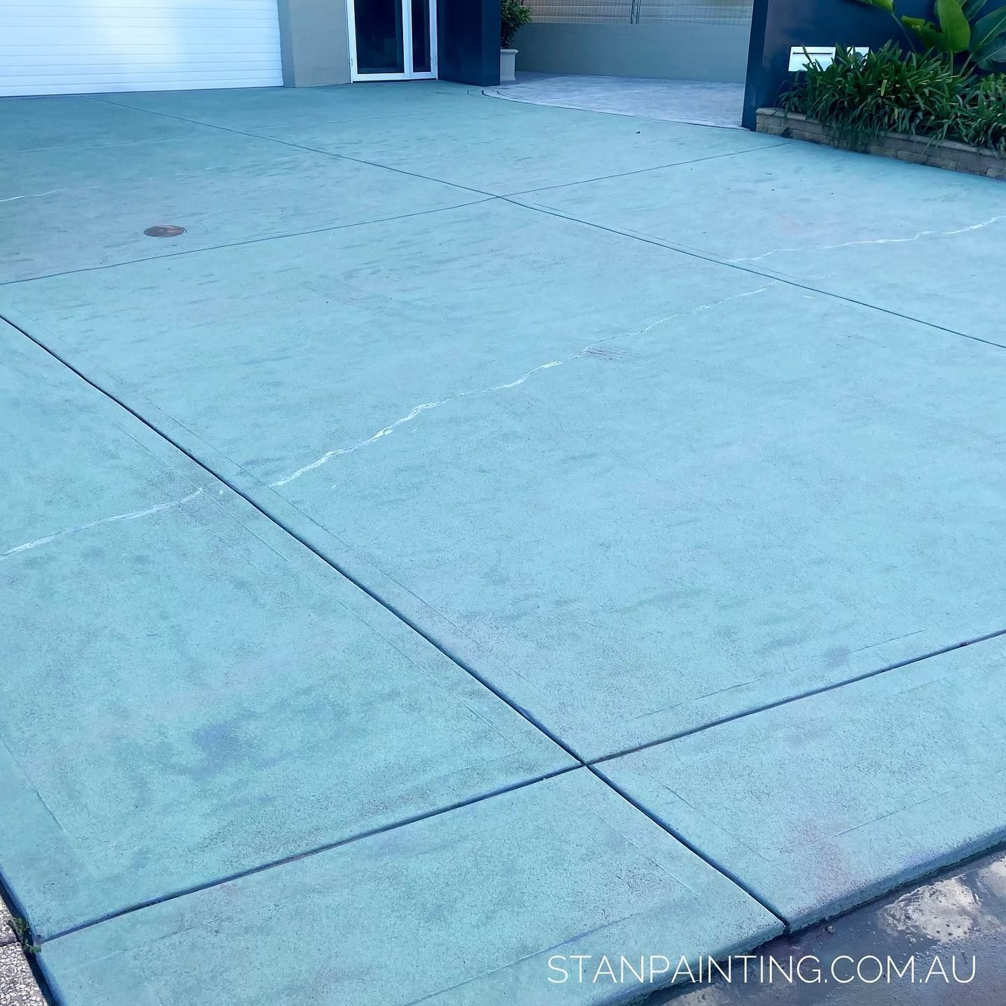 Blue Concrete Driveway with Cracks and Control Joints — Stan Painting Services In Belmont, NSW
