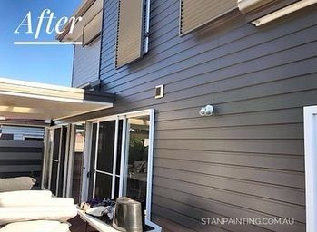 Dark Gray Siding on A House Exterior, with White Trim and Glass Doors — Stan Painting Services In Lake Macquarie, NSW