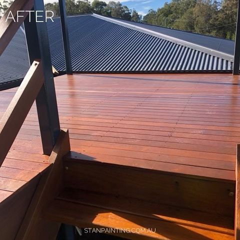 Newly Stained Wooden Deck with Black Roof and Railing in Sunlight — Stan Painting Services In Port Stephens, NSW