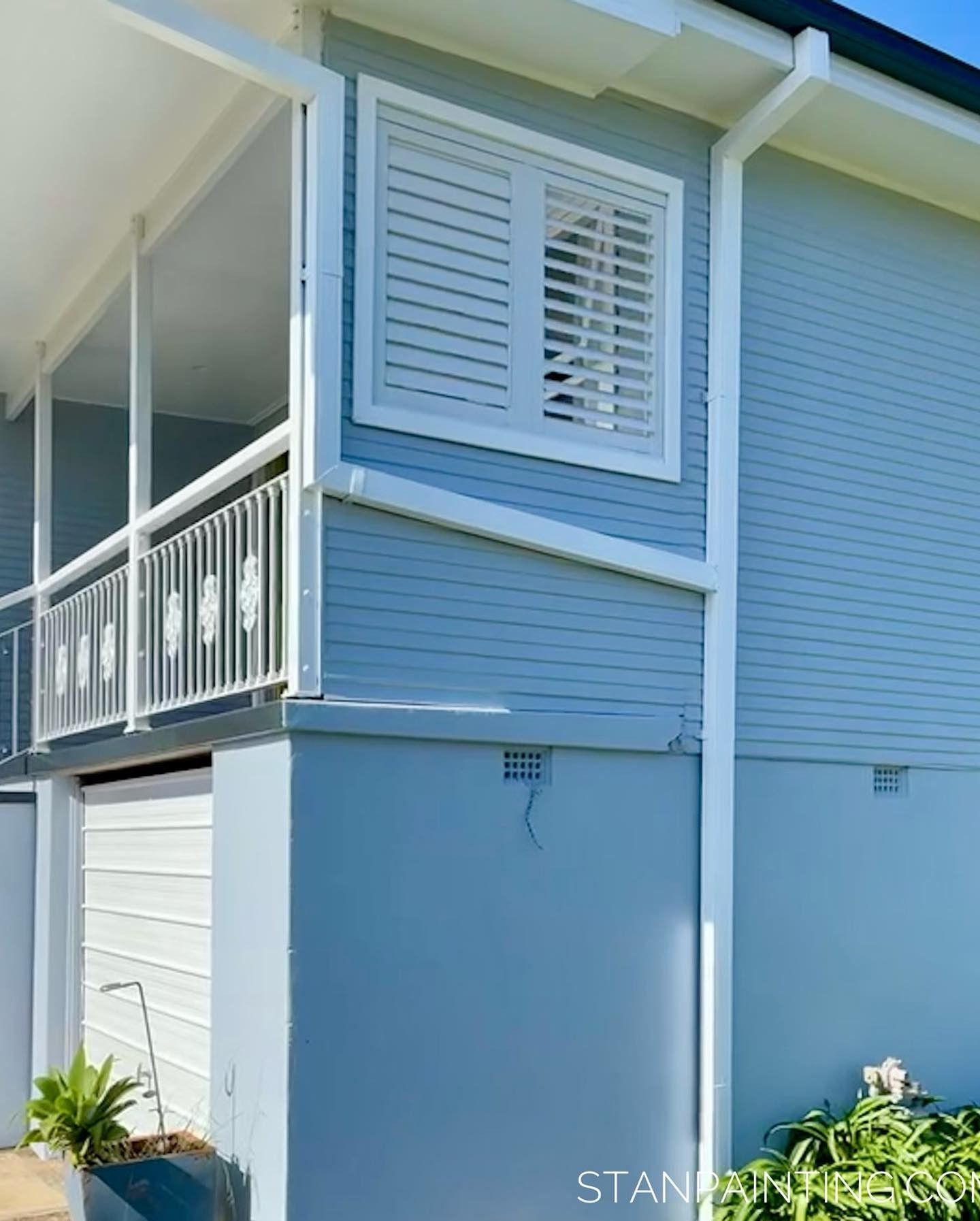 Blue house exterior with white shutters and trim — Stan Painting Services In Lake Macquarie, NSW