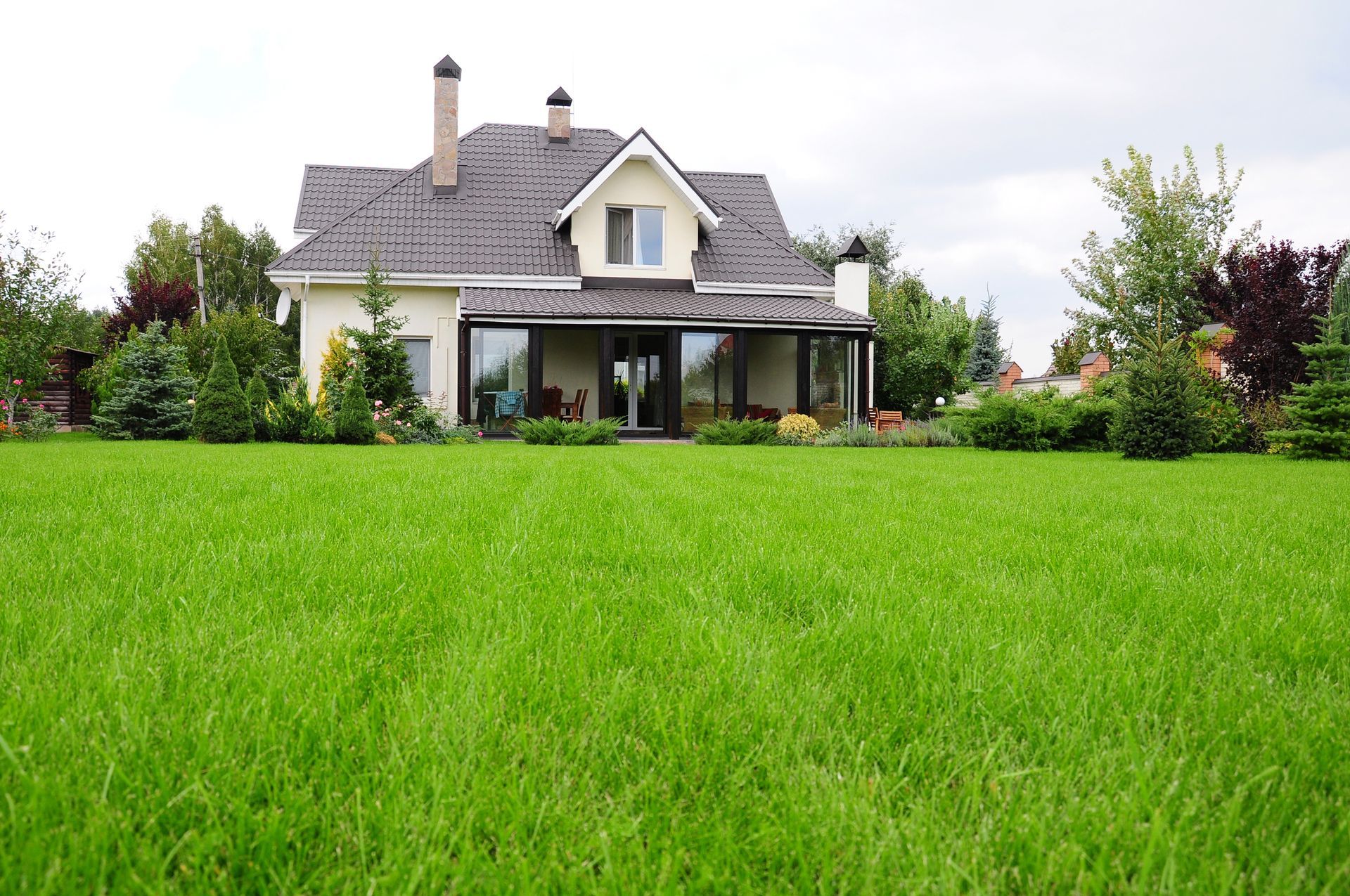 A house with a large lawn in front of it