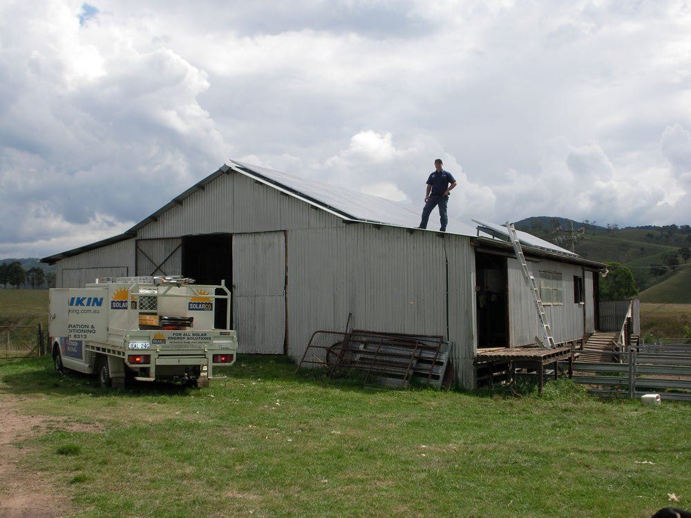 Man on the Roof Installing Solar Power System — Solar Installer in Orange, NSW