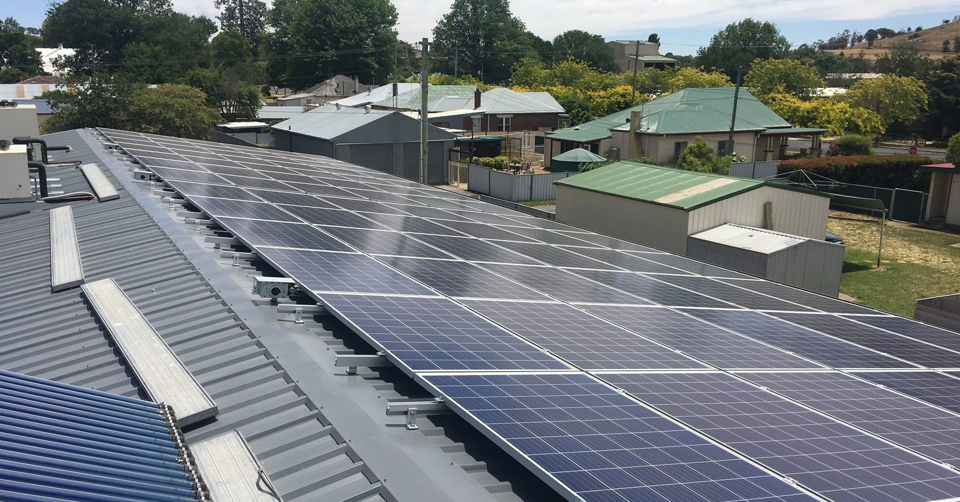 Man holding Wires Besides the Ladder — SOLARCO Central West in Orange, NSW