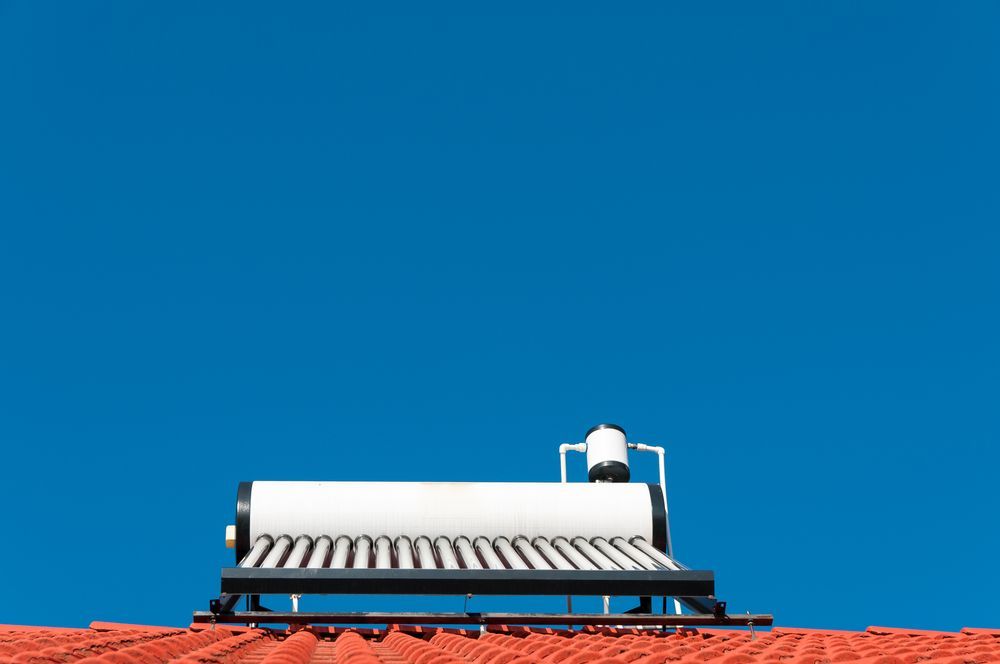 Solar Water Heater on a Red Roof Against a Clear Blue Sky — SOLARCO Central West in Orange, NSW