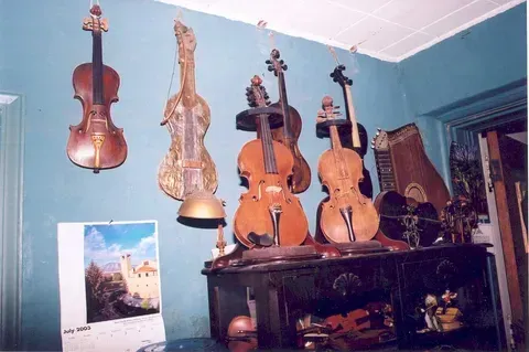 A Bunch of Violins Hanging on a Wall