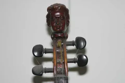 A Violin with a Carved Head on Headstock