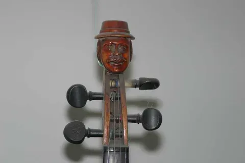 Headstock of a Violin with Carved Face