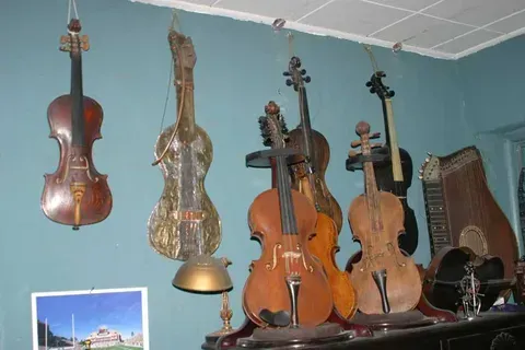 A Bunch of Violins are Hanging from the Ceiling