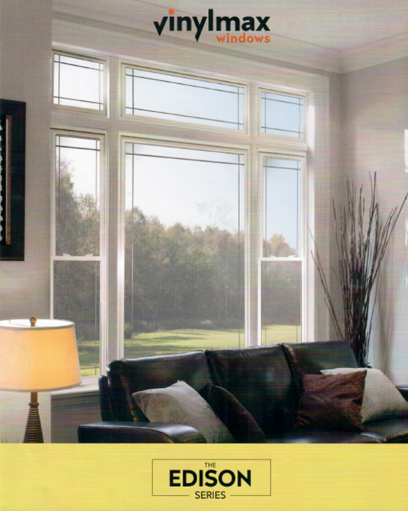 Living room with large windows, Vinylmax Edison series. View of a brown sofa, lamp, and outdoor scenery.