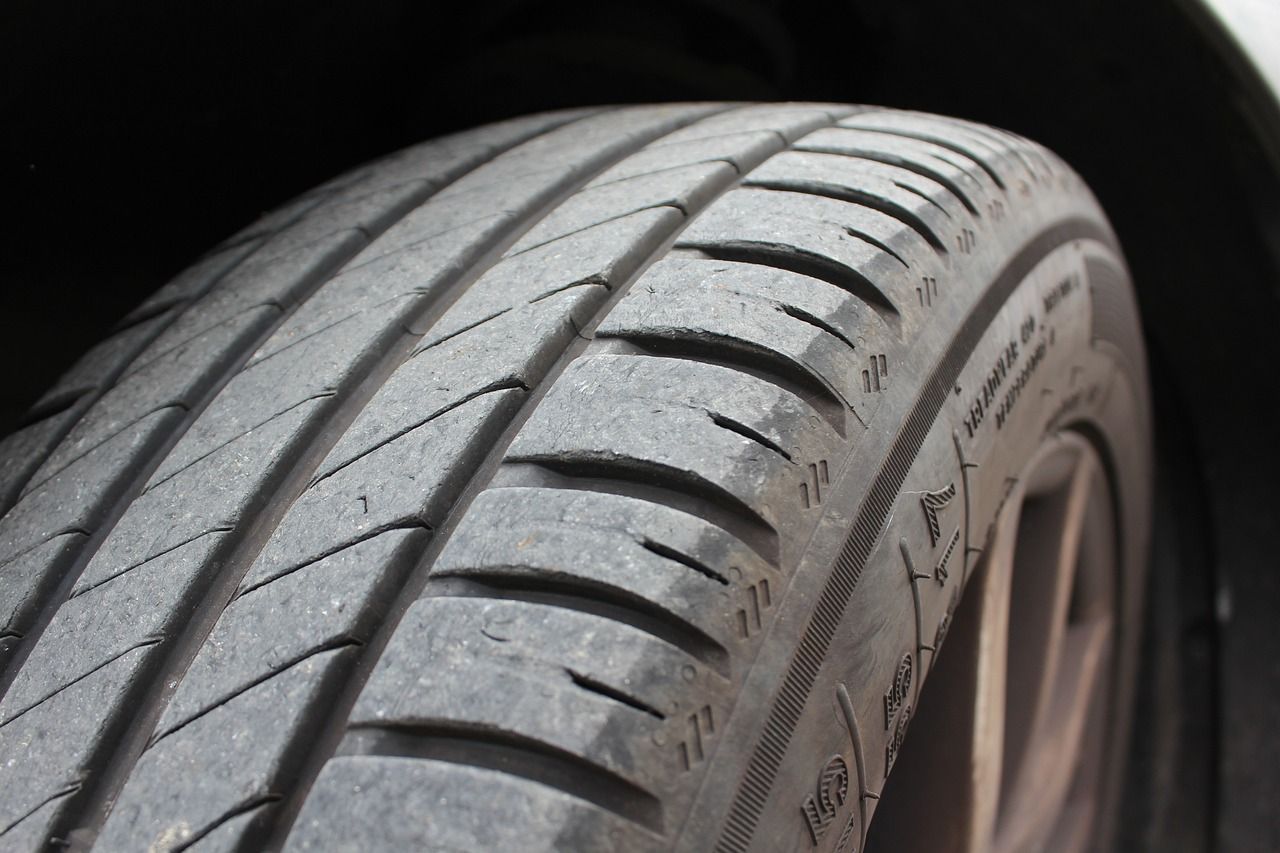 Close-up of a worn car tire tread with visible wear and sidewall details