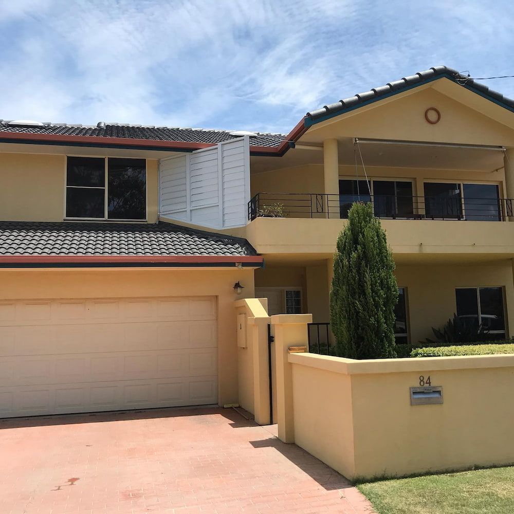 A Large House With The Number 84 On The Side Of It — Ballina Painting Service In Ballina, NSW