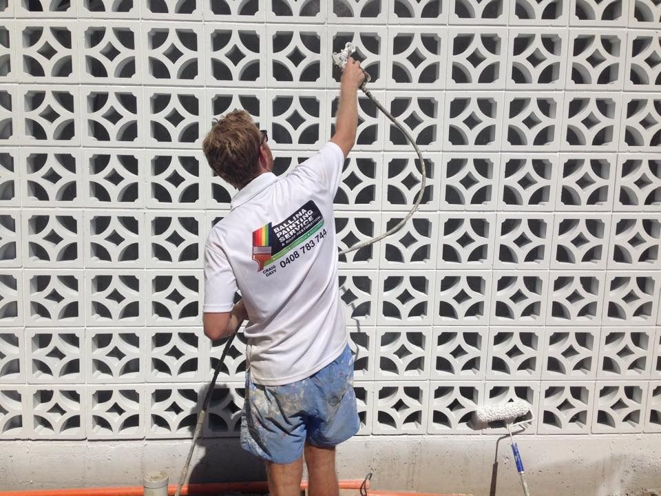 Painter Spray-Paints a White Wall