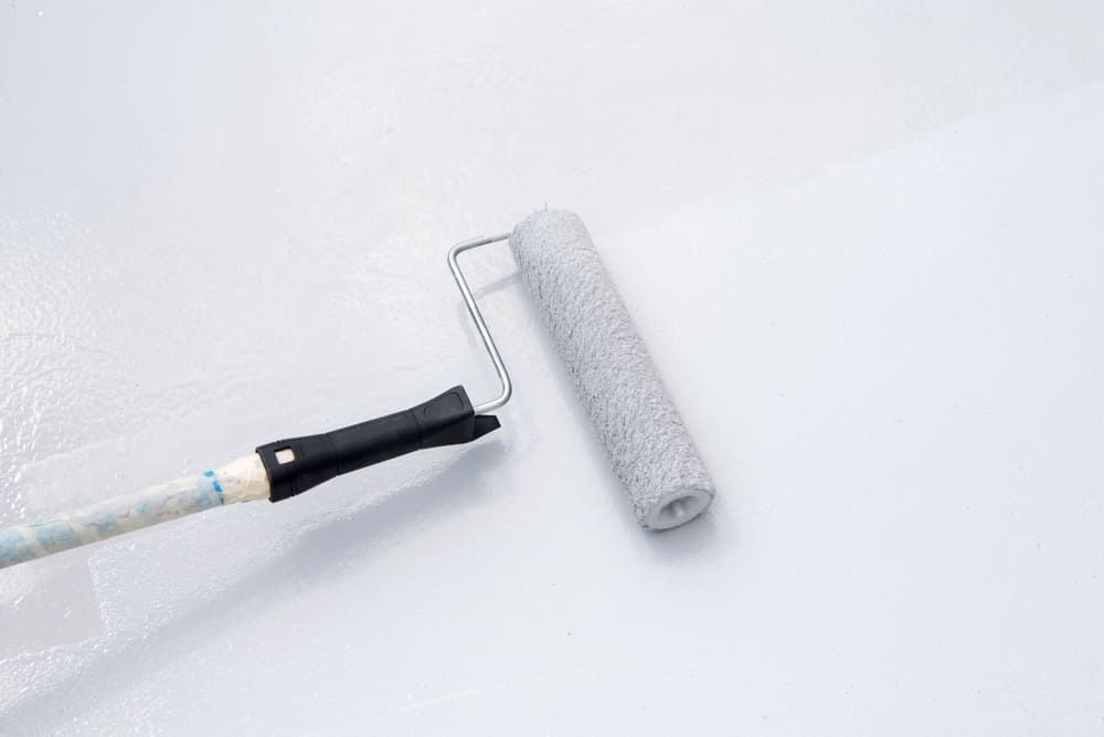 A Paint Roller Is Being Used To Paint A White Wall — Ballina Painting Service In Byron Bay, NSW
