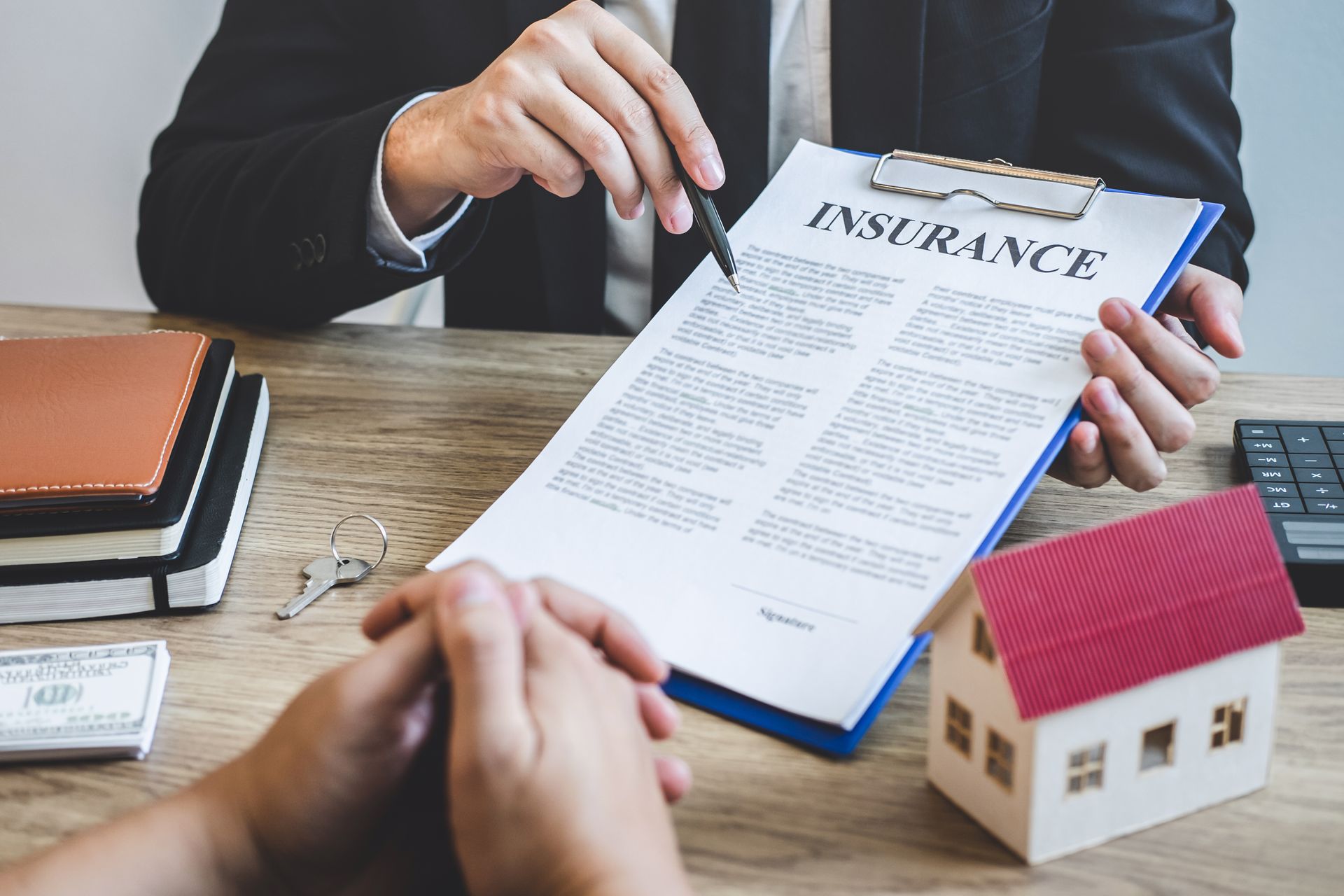 A man is holding a clipboard with a piece of paper that says `` insurance ''.