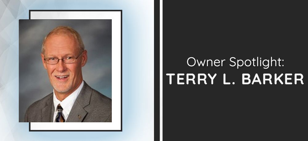 Owner Spotlight: Terry L. Barker smiling, wearing glasses and a suit, with text on a black background.
