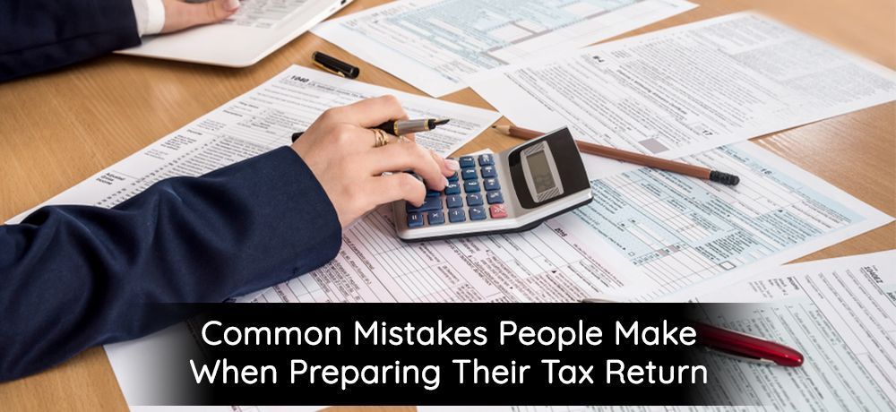 Person calculating taxes with calculator and forms, text reads,
