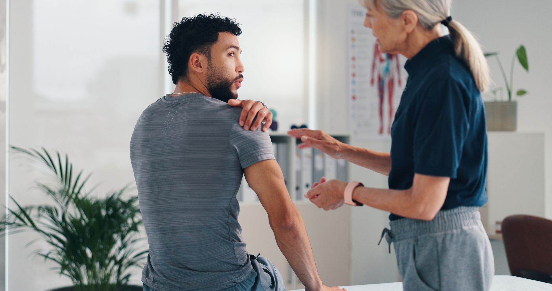 Chiropractor talking of injury, rehabilitation and recovery of joint of male patient muscle. Chiropractor talking of injury, rehabilitation and recovery of joint of male patient muscle.
