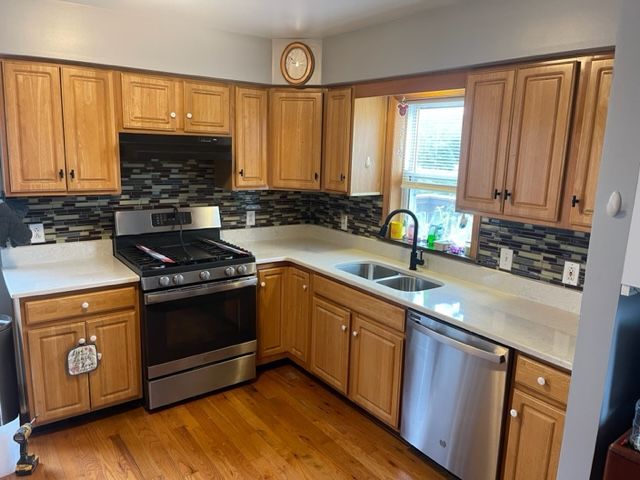 A kitchen with wooden cabinets and stainless steel appliances