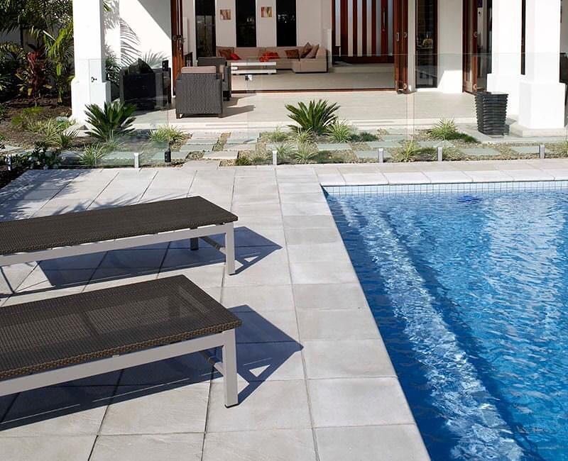 A Swimming Pool With Two Lounge Chairs Next To It — Amber North Coast In Port Macquarie, NSW