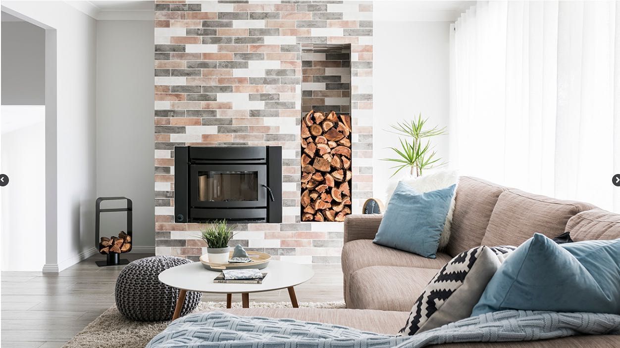 A Living Room With A Couch, Fireplace, And Table — Amber North Coast In Port Macquarie, NSW
