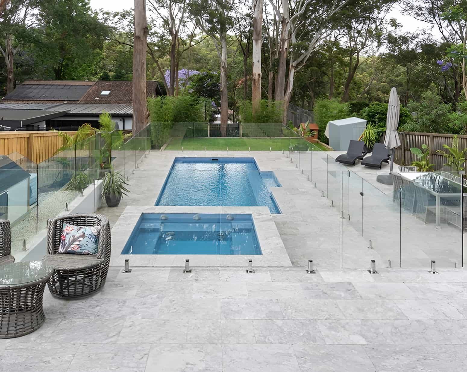 A Large Swimming Pool Is Surrounded By A Glass Fence — Amber North Coast In Port Macquarie, NSW