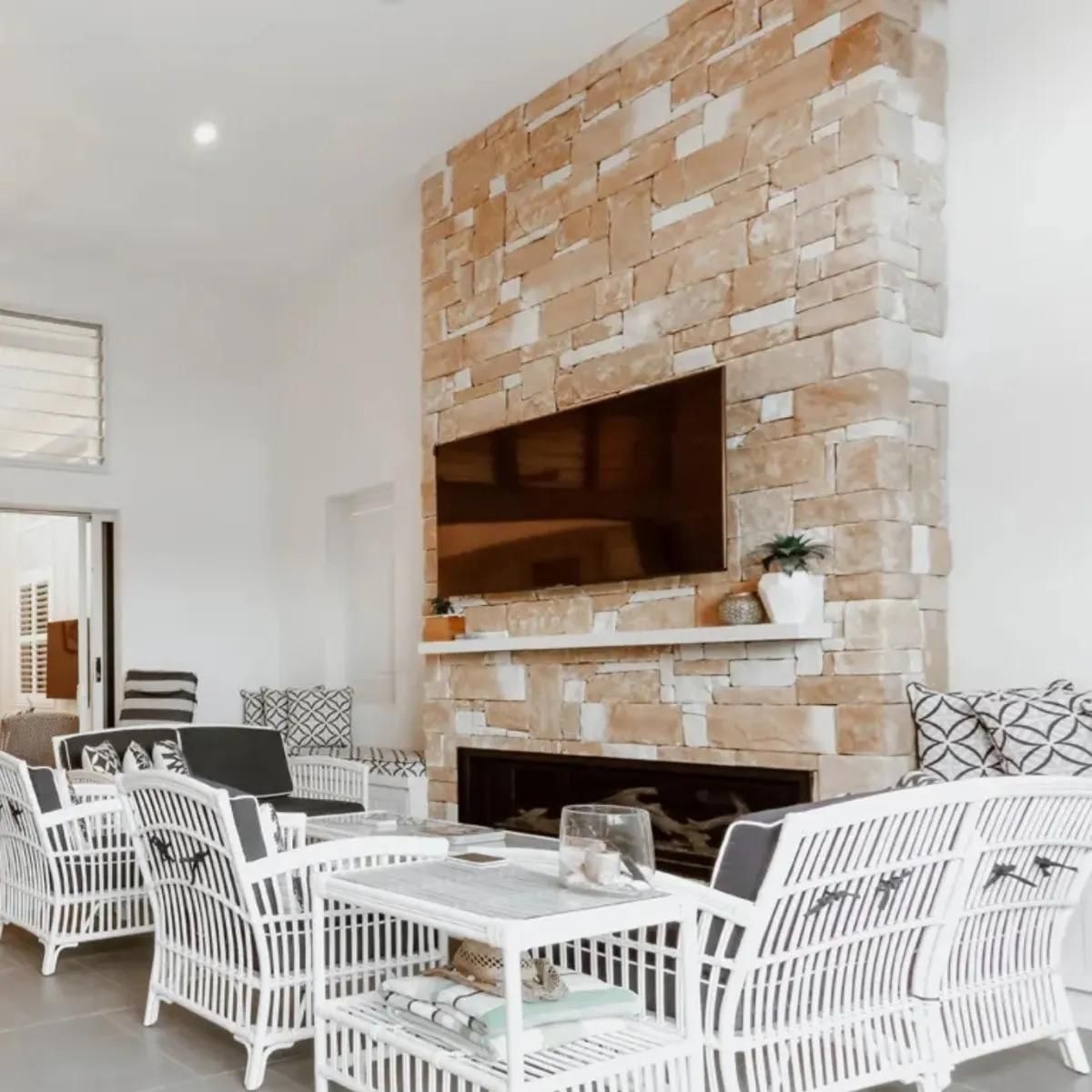 A Living Room With a Fireplace , Couch , Chairs and a Flat Screen Tv — Amber North Coast In Port Macquarie, NSW