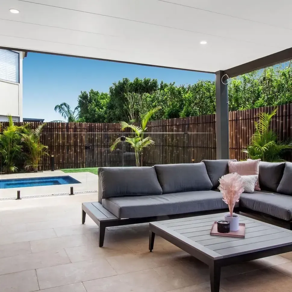 A Patio With A Couch Table And Pool In The Background— Amber North Coast In Port Macquarie, NSW