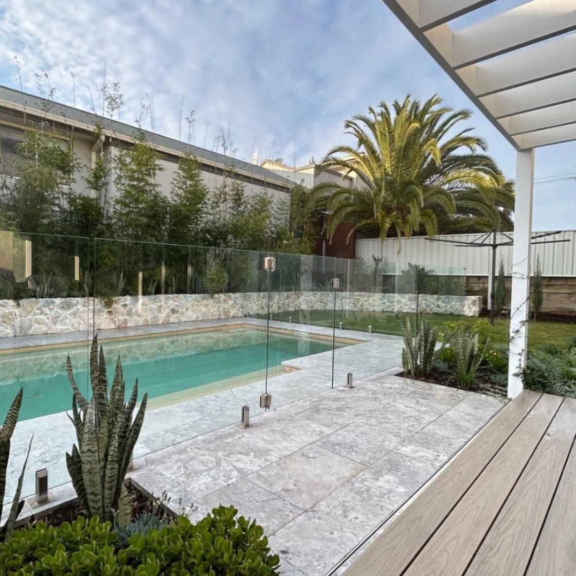 A Large Swimming Pool is Surrounded by a Glass Fence — Amber North Coast In Port Macquarie, NSW