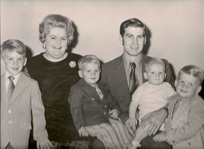 A black and white photo of a family posing for a picture