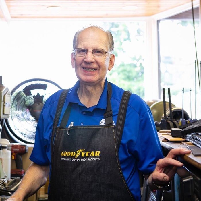 A man wearing an apron that says good year on it