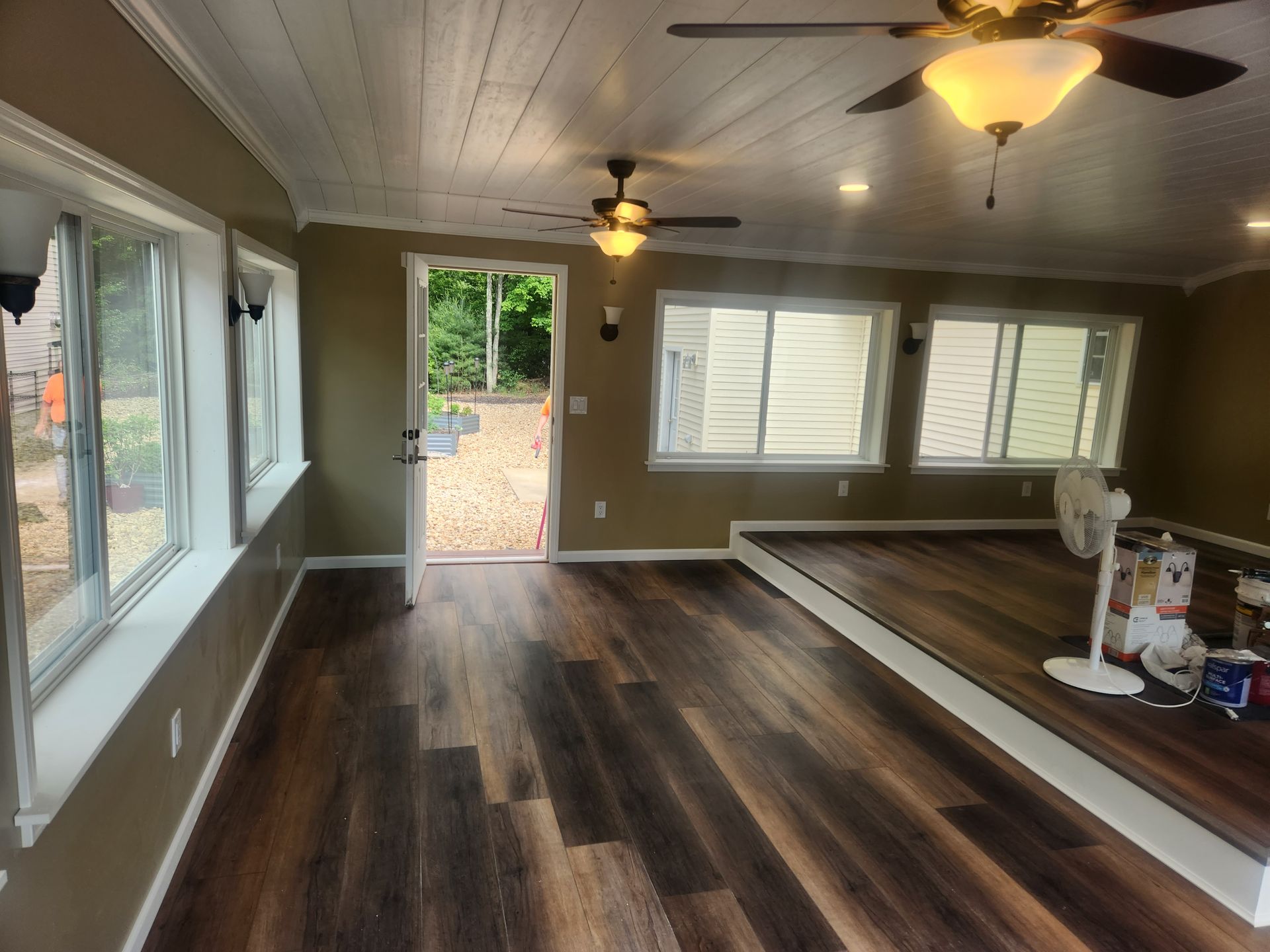 A living room with hardwood floors and a ceiling fan