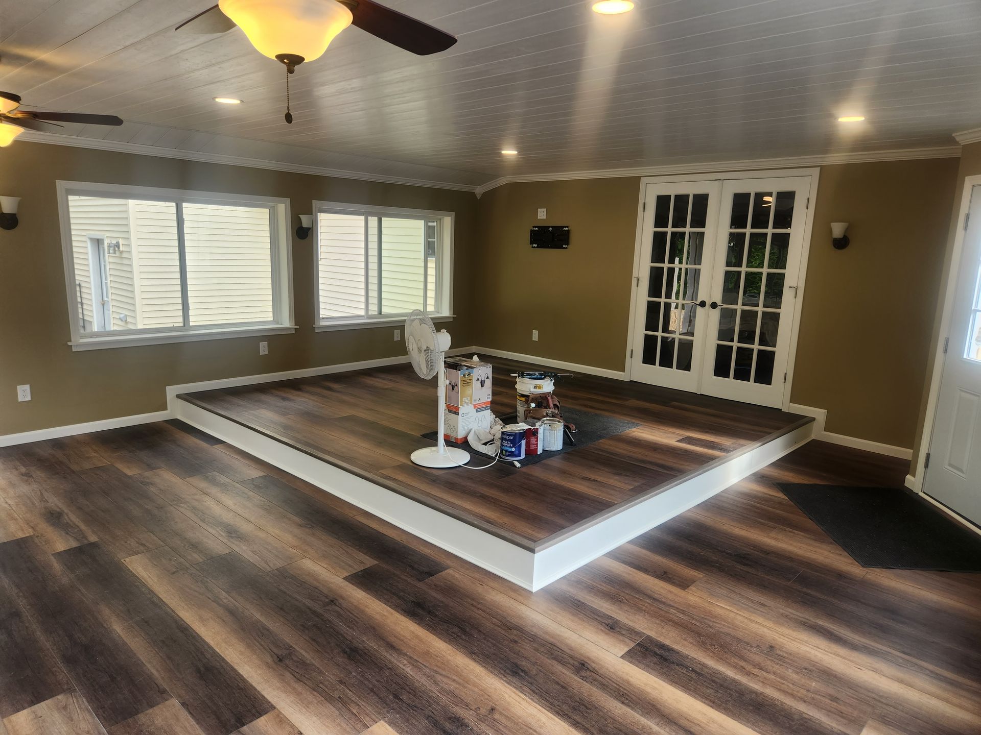 A living room with hardwood floors and a ceiling fan
