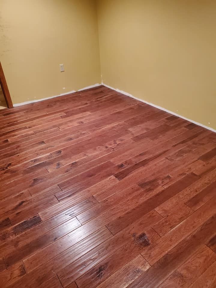 A room with hardwood floors and yellow walls.