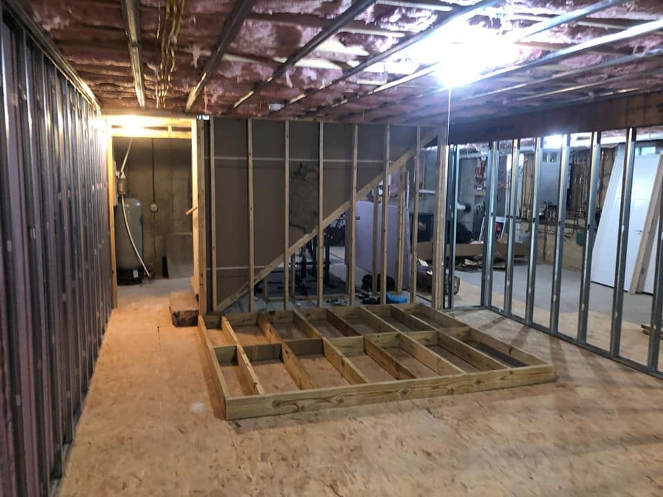A basement under construction with a wooden floor and walls.