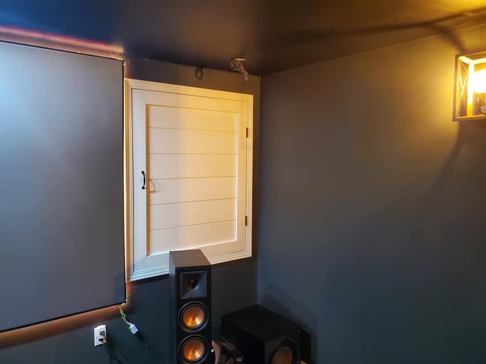 A room with a window and speakers in it