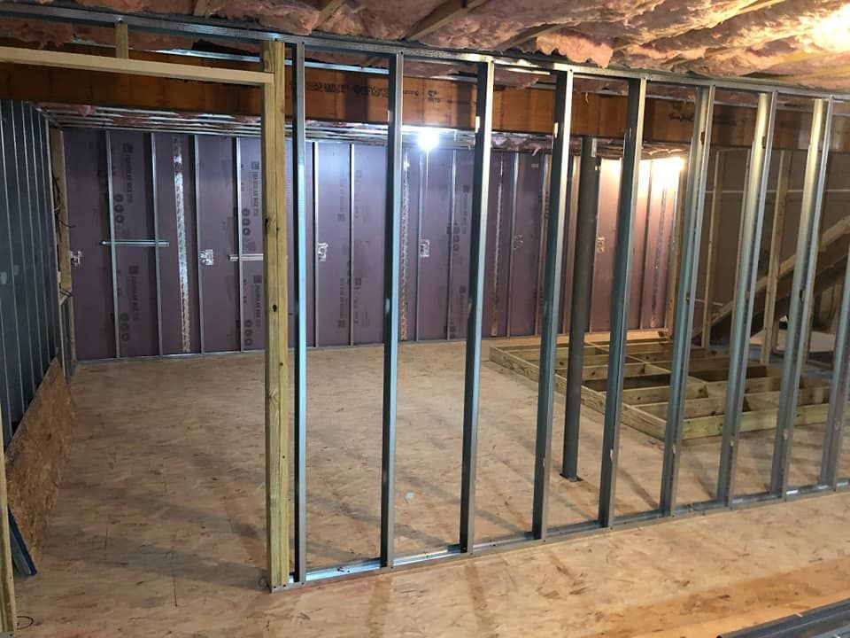 A room with a lot of metal frames and wooden walls