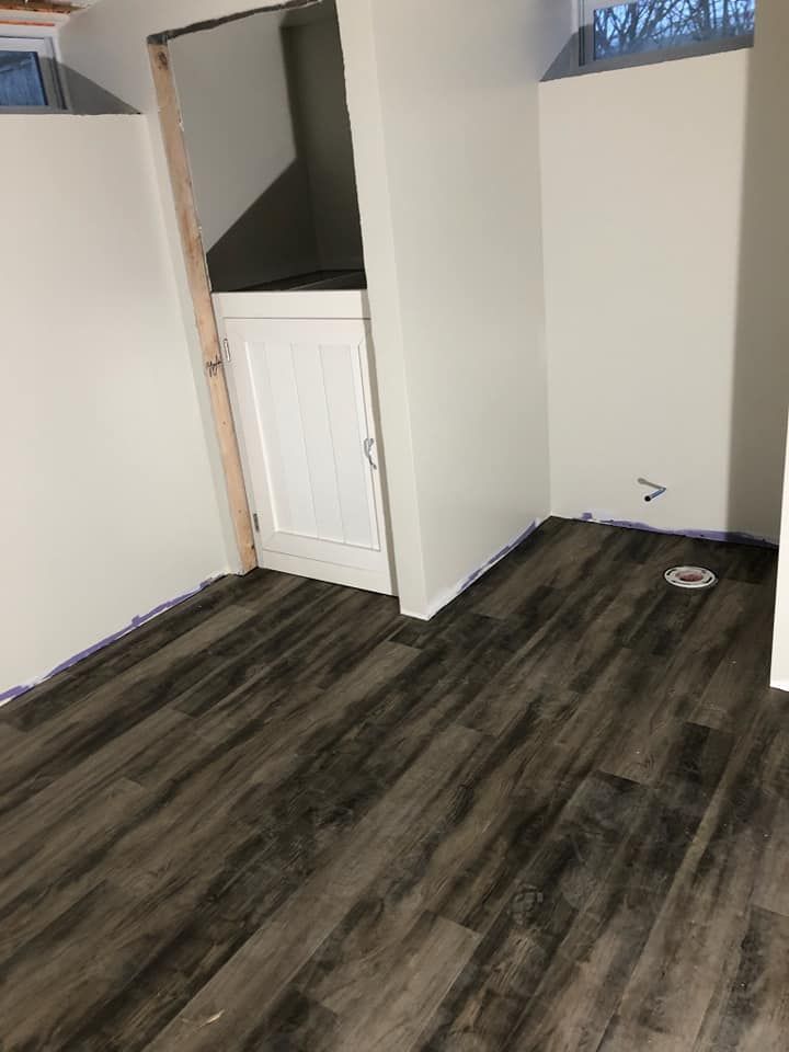 A room with a wooden floor and white walls.