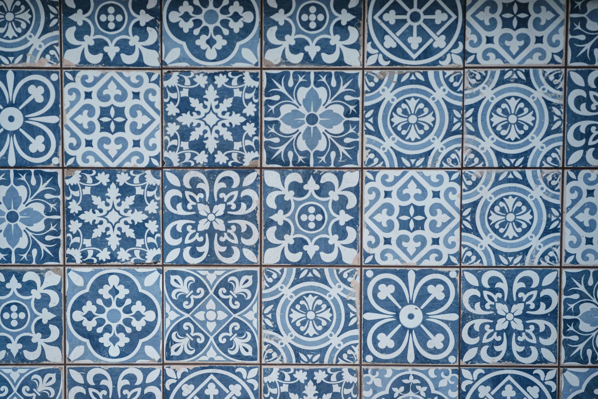 Blue and white porcelain wall pattern with detailed floral and geometric designs.